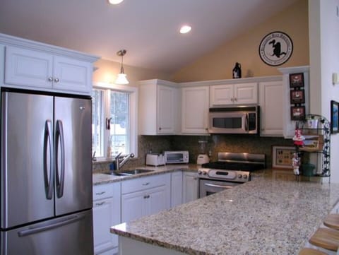 All S/S kitchen with window to the backyard deck and The Great Room.