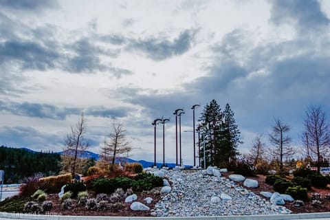Crossing to walk to the Spokane River, you witness a beautifully designed traffic circle with a fish sculpture featured above the well-manicured landscape