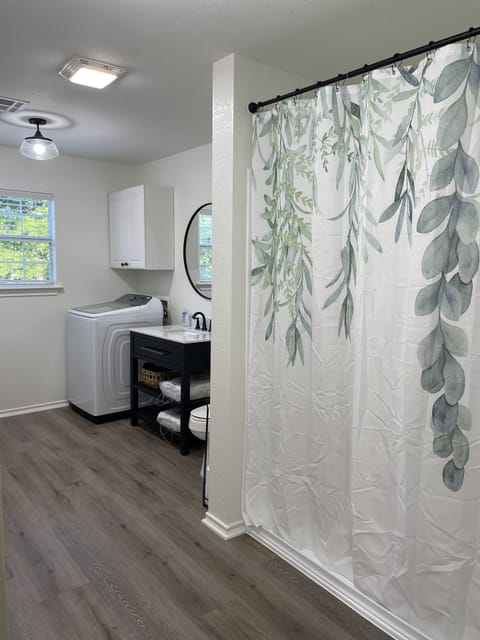 Bathroom/laundry space features 3x5 walk-in shower & large capacity washer/dryer