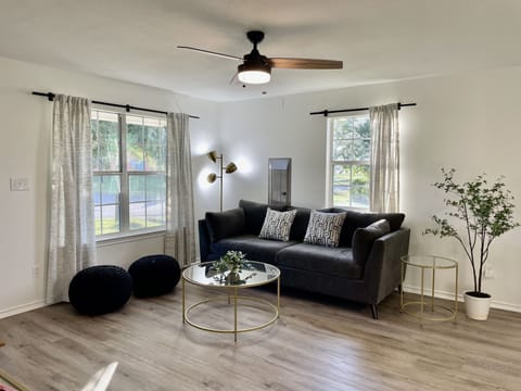 Cozy living room features queen memory foam mattress sleeper sofa & 50" Smart TV