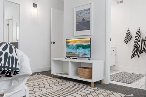 The cozy primary bedroom, with a queen bed and 43'' TV