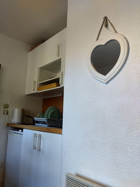 Kitchenette with ceramic hob, fridge, slow cooker, kettle, toaster, pans etc