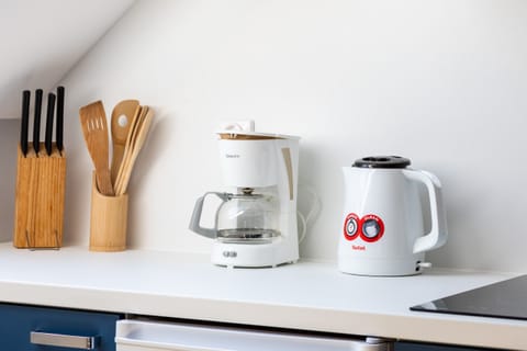 A close-up of the kitchen table, showcasing bright yellow flowers and a cheerful ambiance.
