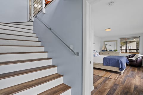 Stairs leading to 2nd bedroom, 3rd bedroom, additional bathroom and laundry.