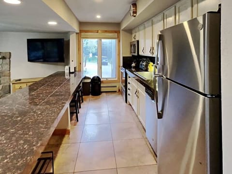 The beautiful, updated kitchen is fully equipped with high-end finishes from the granite countertops and stainless steel appliances to the large sink and ample cabinet space. The spacious bar provides seating for six.