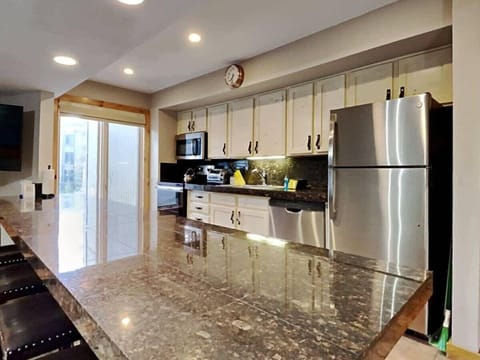 The beautiful, updated kitchen is fully equipped with high-end finishes from the granite countertops and stainless steel appliances to the large sink and ample cabinet space. The spacious bar provides seating for six.