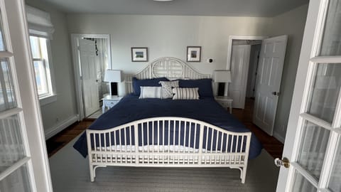 Master bedroom with king bed and French doors that open to sunroom