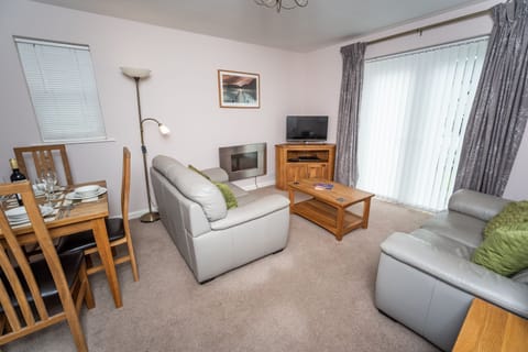 A pleasant living and dining area with patio doors to the shared garden