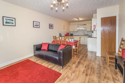 The large open plan kitchen and dining area is also furnished with a sofa and smart TV
