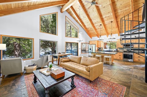 Open concept living room looking out on the beautiful forest.