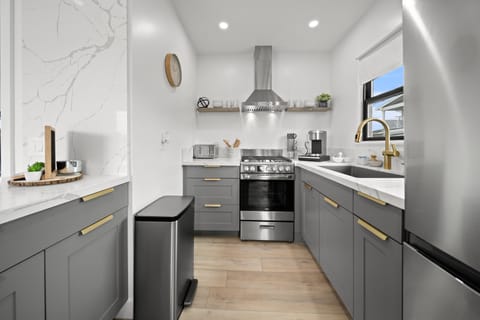 Fully stocked kitchen with coffee maker, toaster and dishes. pots and pans