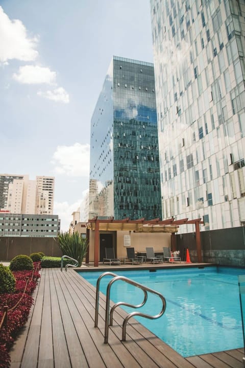 Enjoy the outdoor pool located on the building premises, offering both a serene environment for a swim and a fun-filled atmosphere. Dive in and indulge in refreshing swims while also embracing the playful side of the pool area.