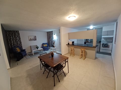 Wide angle image of dinning room, kitchen, and living room . 