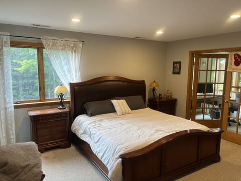 Master Bedroom with king size bed, gas fireplace and balcony with workstation