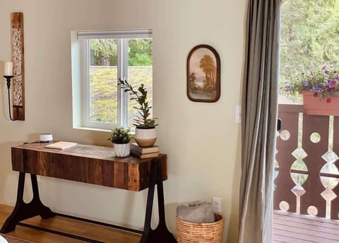 The king-size bed faces a beautiful wood and iron console and one of the two private balconies.