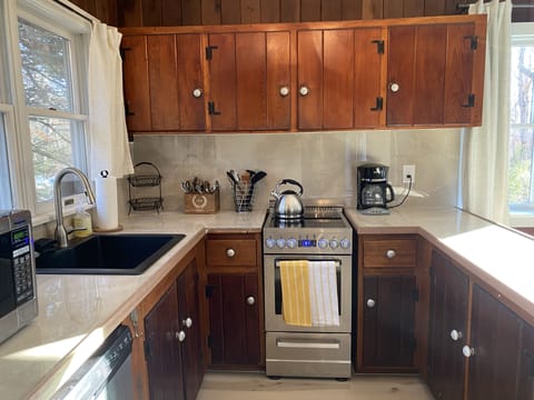 Fully equipped kitchen with dishwasher, stove, oven.