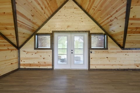 Step out onto the upper deck and take in peaceful water views from this cozy, cabin-style nook.