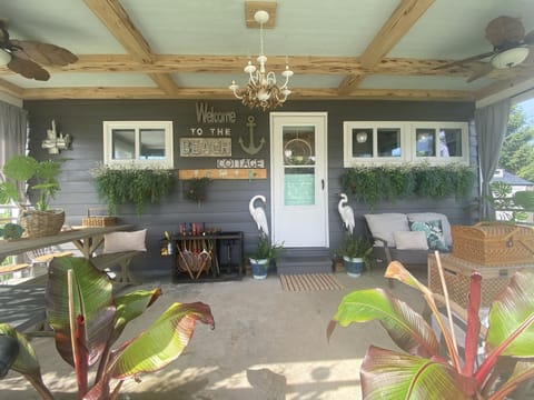 Private Covered Porch has 2 ceiling fans, table for 6 and soft seating.