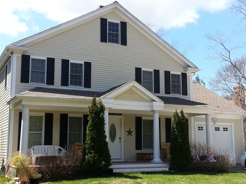 Front of house with shaded front farmers porch to relax read or have coffee