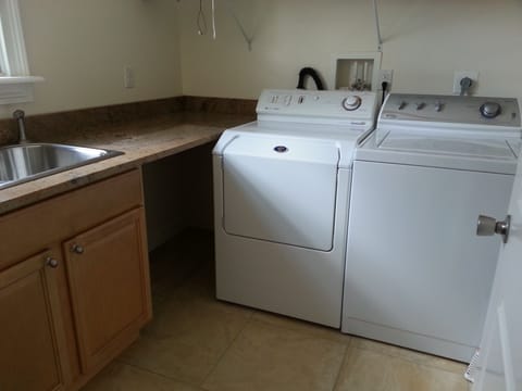 Laundry room with additional sink off of pantry on first floor.