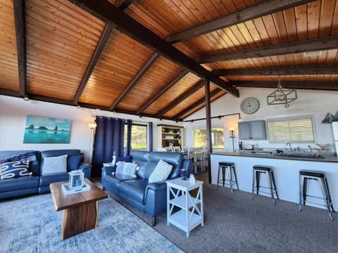 Spacious lounge under soaring beams, perfect for relaxing together.