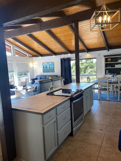 Open kitchen & dining area w/ warm wood accents.