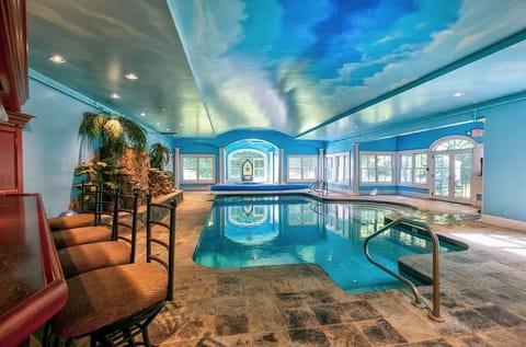 Pool room with hot tub and bar.