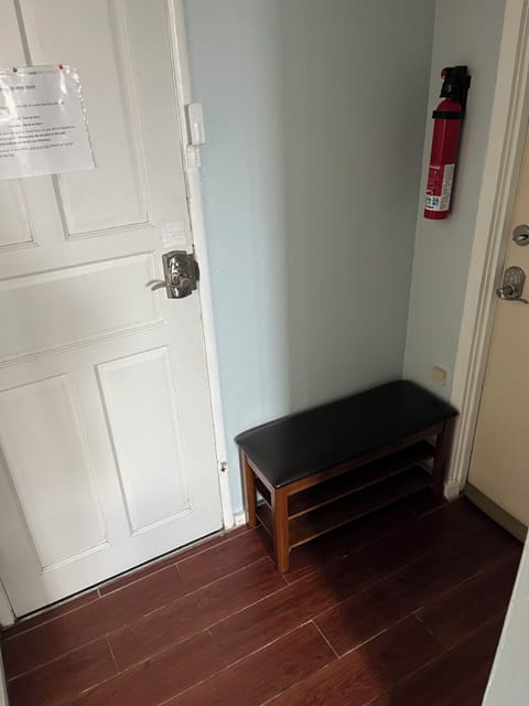Studio Entryway has sit-down shoe rack and extra space for luggage