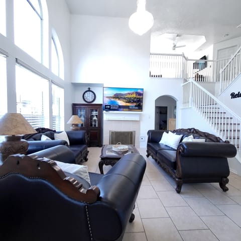 Main Living room, High ceiling Chandelier, Leather furniture, 75" Hdtv, Wifi