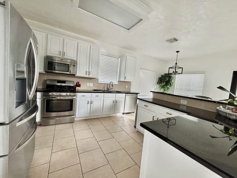 Kitchen with All Stainless-steel appliance, Granite bar style counter tops.