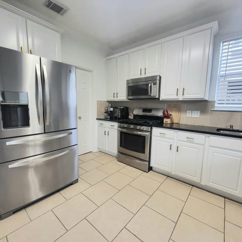 Kitchen with All Stainless-steel appliance, Granite bar style counter tops.