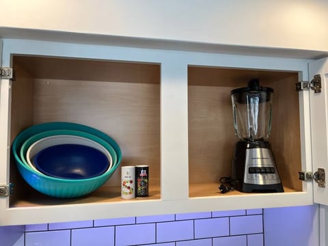 Mixing bowls, blender, and salt + pepper contribute to the fully equipped kitchen.