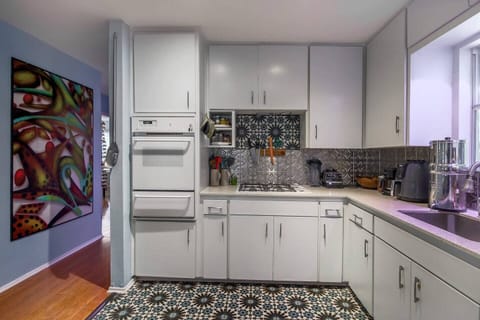 Fully stocked kitchen. Funky tile. Plenty of counter space & clean, clean, clean!