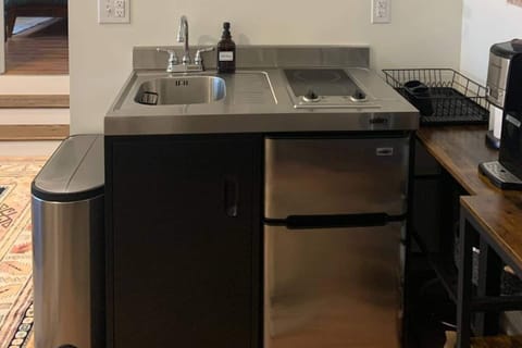 Functional kitchenette with two burner stove, mini sink, refrigerator and freezer.