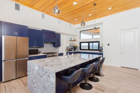Gourmet eat-in chef's kitchen with oversized waterfall island.