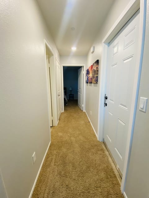 Hallway to restroom on left. And bedroom straight down