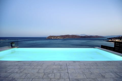 An infinity pool, a heated pool, sun loungers