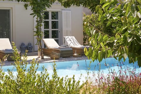 A heated pool, sun loungers