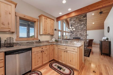 Kitchen open to dining and split share fireplace.