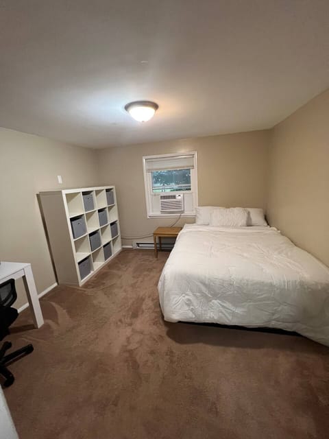 Bedroom 1 with computer desk, walk in closet, Queen bed, end table, and Organizer clothes and any other items with or without bins 
