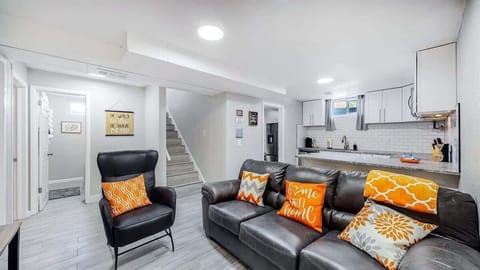 The living area features a comfortable, stylish sofa, perfect for unwinding after a long day. Whether you're watching TV, reading a book, or enjoying conversation, it’s the ideal spot to relax and feel at home.