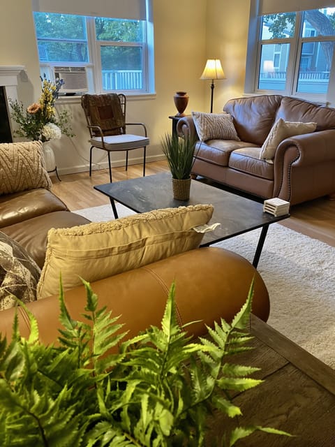 The living area exudes comfort and sunlight. Come Live The Boulder Life.
