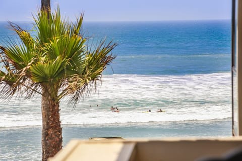 Watch swimmers and boogie boarders in the waves from your balcony!