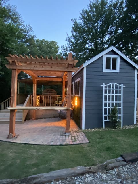A Serene Hideaway — Side View Highlights the Cozy Deck and Peaceful Outdoor Vibes