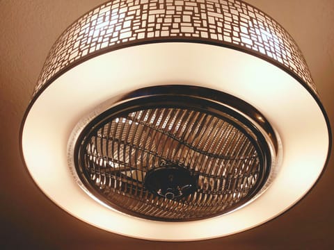 Luxurious motion ceiling fan above living room, blades are inside 
