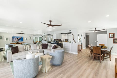 Spacious open-concept living room with direct flow into dining and kitchen spaces.