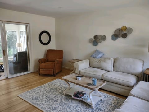 Open floor plan, living room with sliding door to sunroom