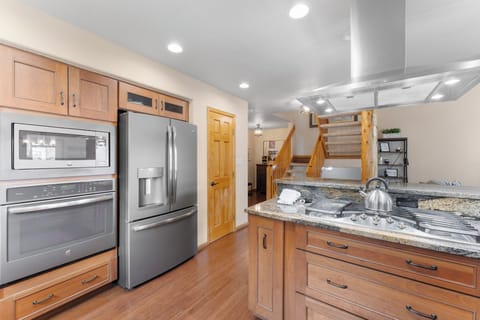 Full-sized luxury kitchen with breakfast bar seating for casual dining.