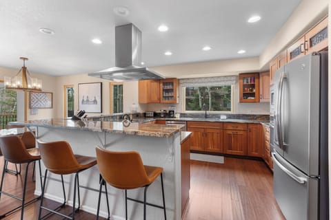 Full-sized luxury kitchen with breakfast bar seating for casual dining.