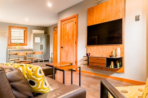 Main floor living room with dining or game table beyond.